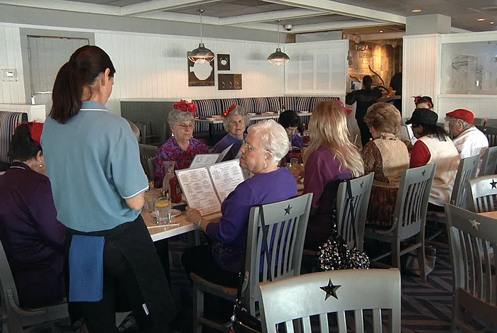 Restaurant waitress taking orders at table